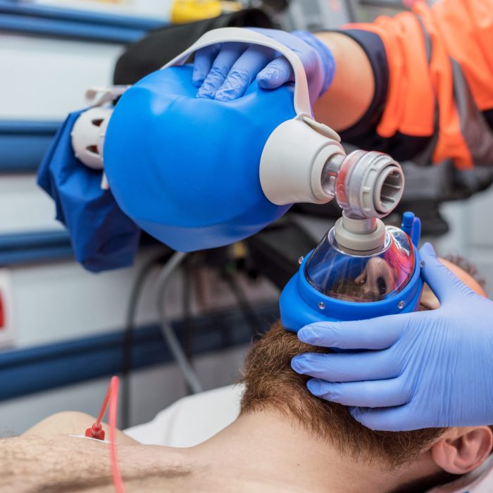covid 19 respiratory insufficiency. urgency doctor using mask ambu bag on a patient with pneumonia due to coronavirus infection, for artificial ventilation.