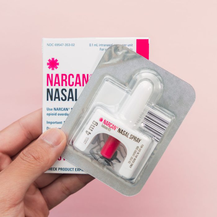 hand holding a narcan evzio naloxone nasal spray opioid drug ove