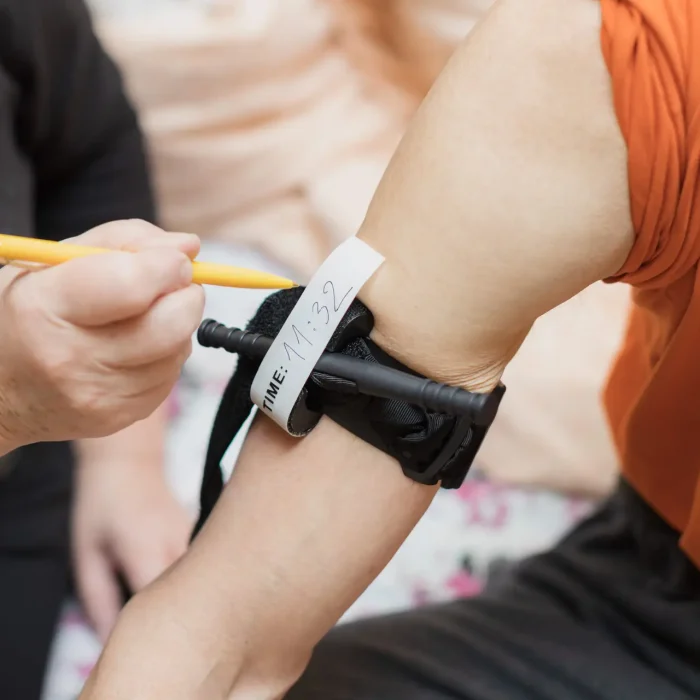 writing a time on applied tourniquet caucasian older man